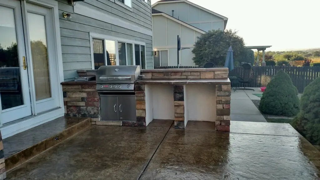 Outdoor living space with grill, seating and pergola by FRSR