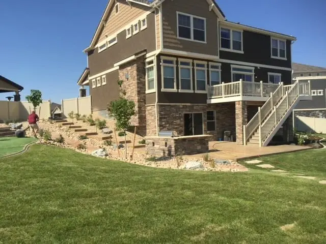 Colorado backyard with stamped concrete patio and integrated planting