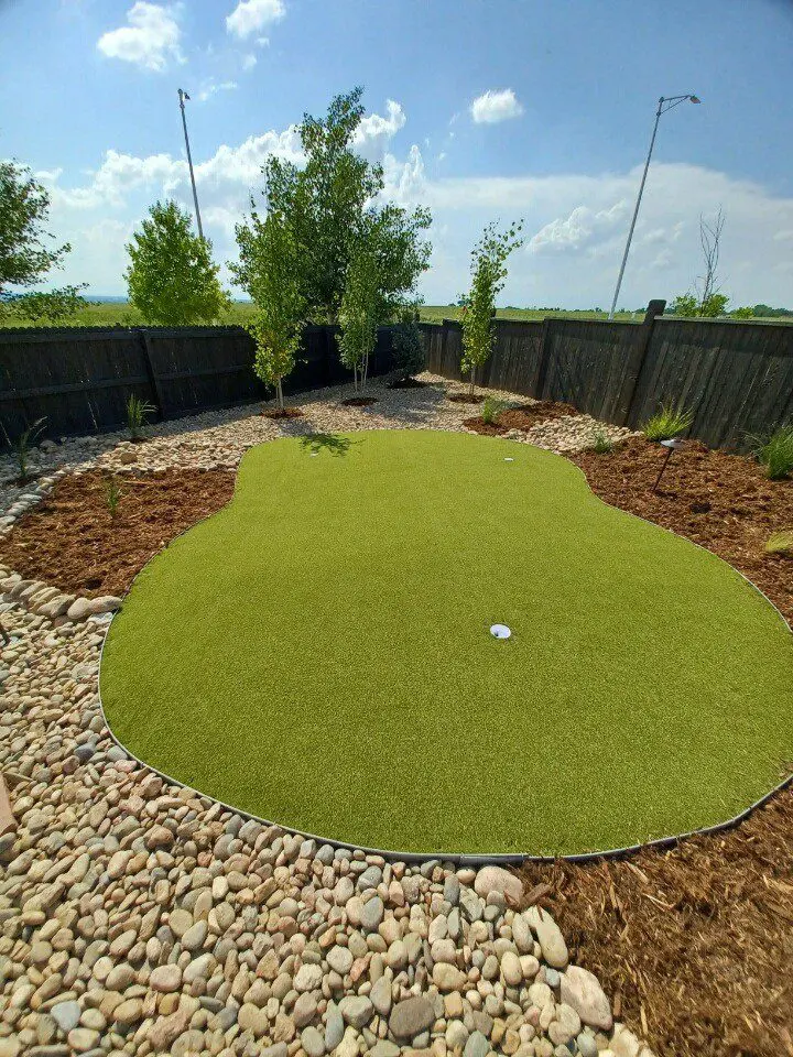Artificial turf lawn installed next to patio in Colorado outdoor living space