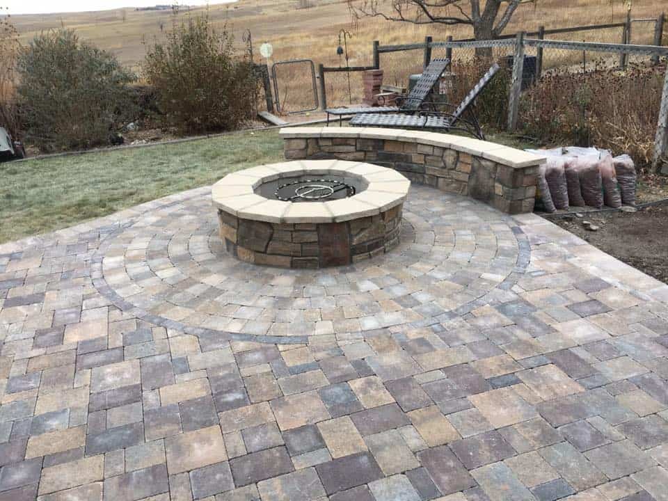 Outdoor fireplace and stone patio by FRSR