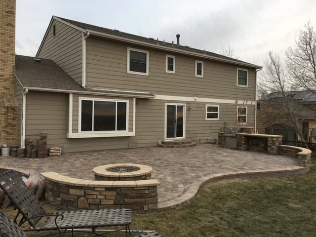 Circular fire pit with seat wall and patio outdoor living