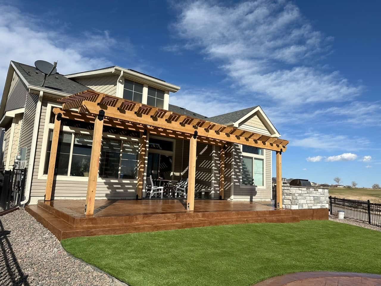 Pergola with stone columns and outdoor living area