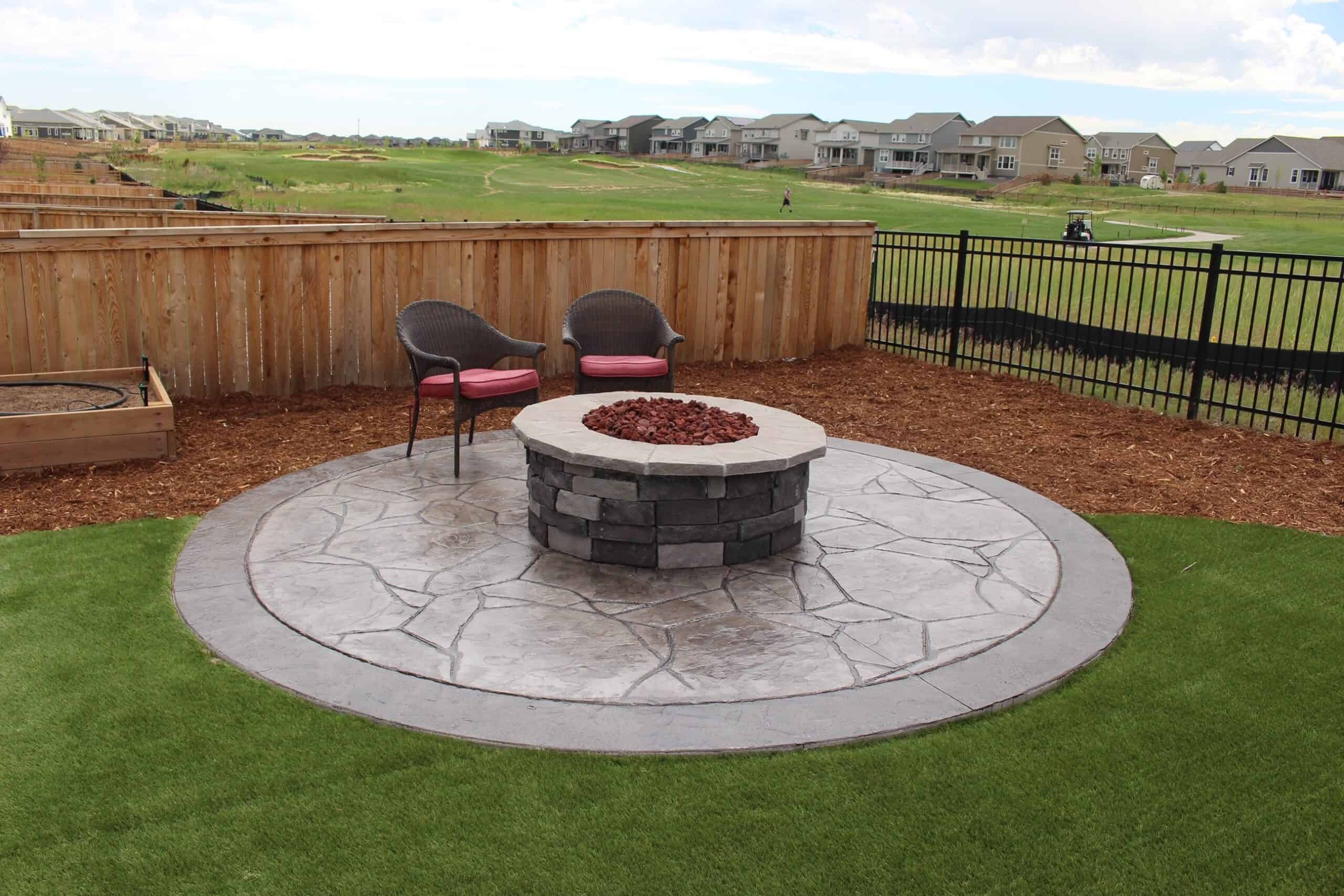 Large paver patio with modern steel fire feature