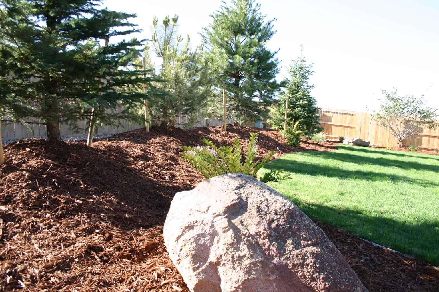 Stamped concrete patio with rock mulch and plantings by FRSR in Superior