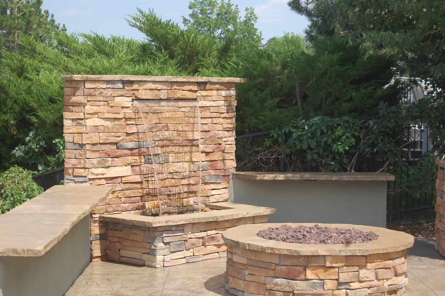 Curved seat wall and fire pit on stamped concrete patio
