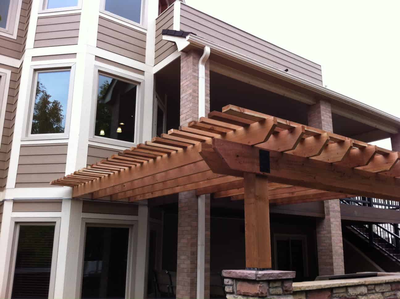Backyard pergola with integrated landscape beds and turf