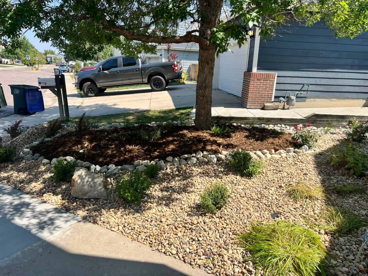 After: xeriscape with rock, shrubs and perennials