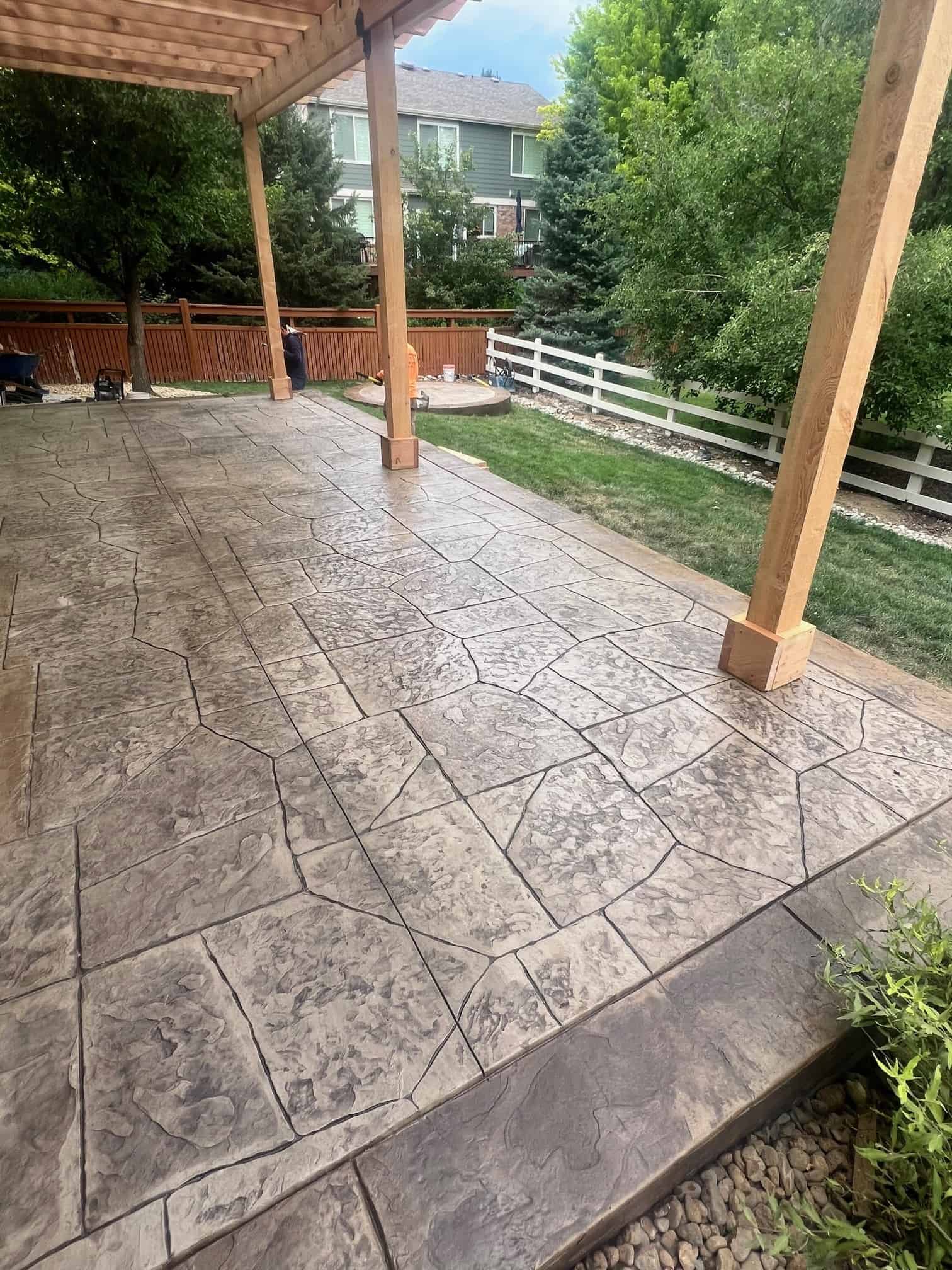Thornton stamped concrete patio with outdoor living space by FRSR