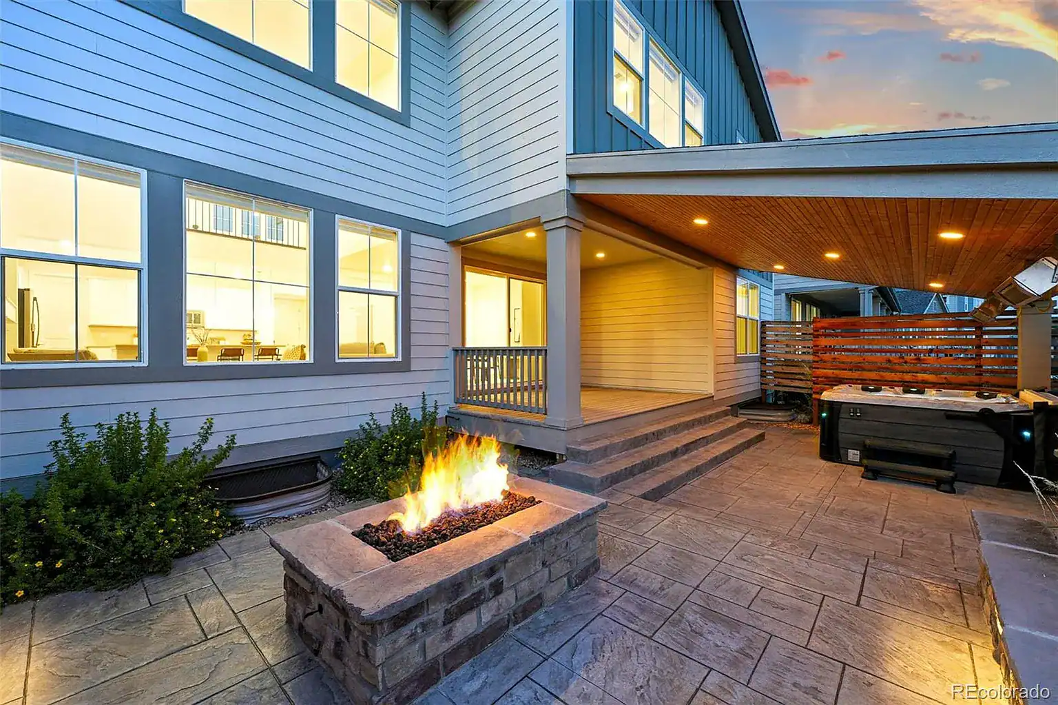 Paver patio and stone fire feature by FRSR