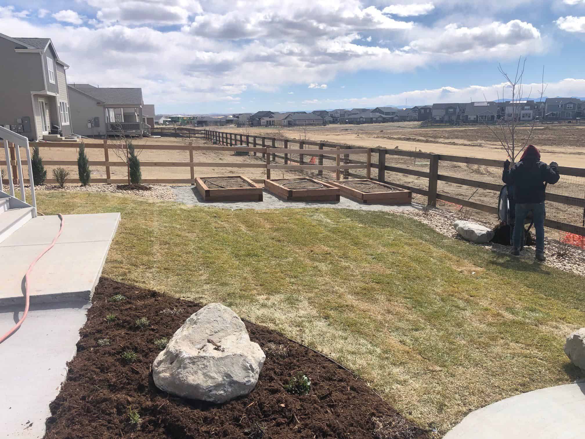 Dix project in Barefoot Lakes Firestone with concrete patio boulders sod and planters
