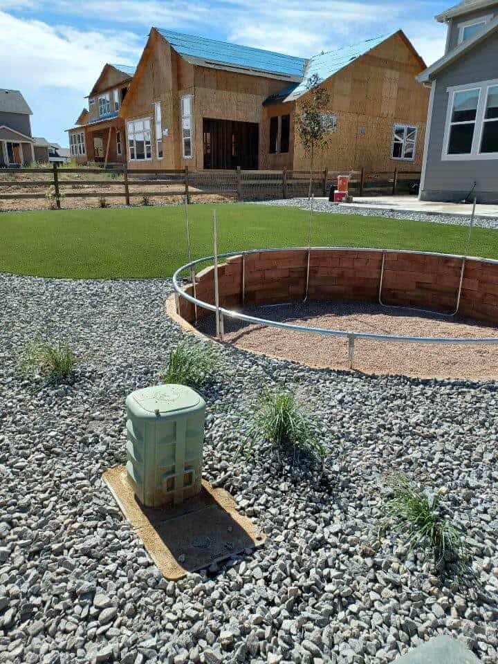 Firestone backyard with concrete patio artificial turf and planting by FRSR