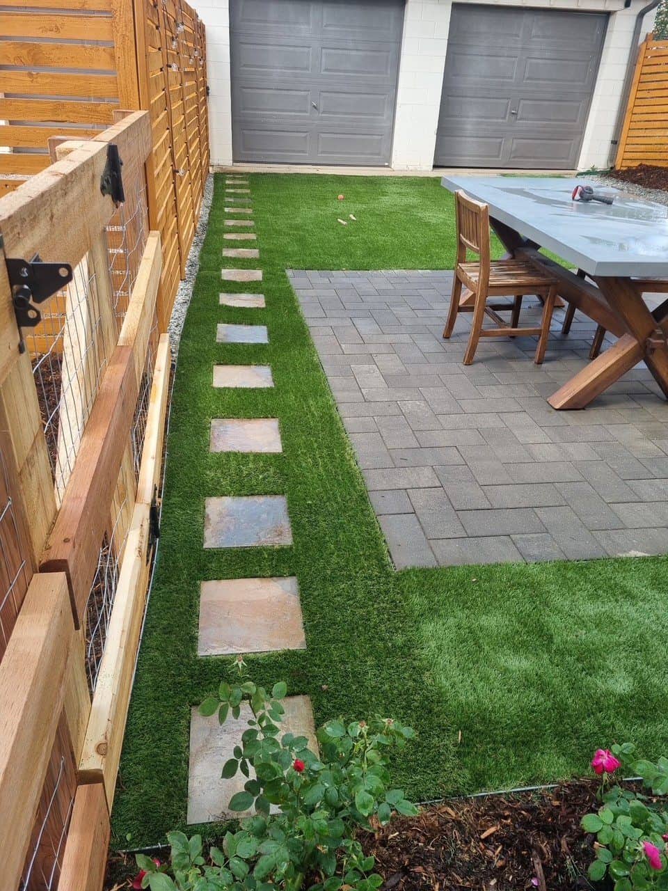 Low-maintenance Colorado landscape with artificial turf, rock, plants, and water-wise outdoor living design