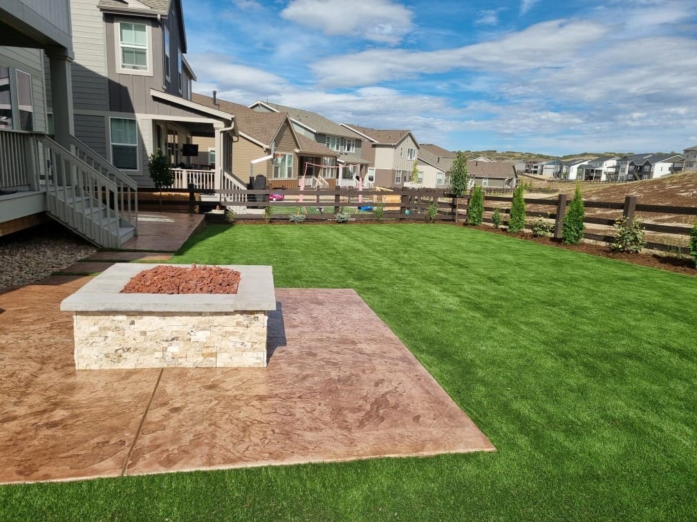 FRSR artificial turf lawn with stamped concrete patio, steppers and firepit in Colorado